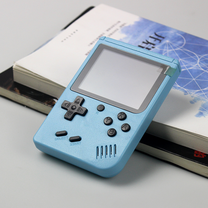 light blue handheld gaming device on books