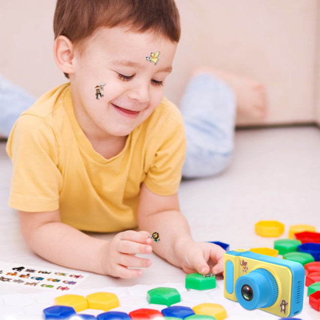 child playing with stickers, camera