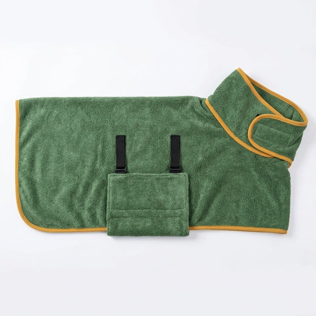 A green plush pet blanket with yellow trim and a front pouch pocket with two black clips, laid flat on a white background.
