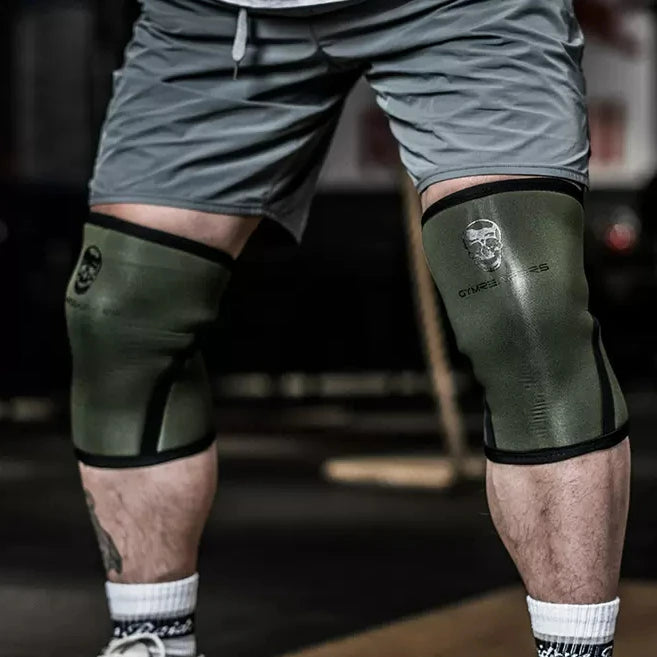 Pro Knee Pads 7mm placed next to barbell — essential gear for squatting, deadlifts and bodybuilding workouts